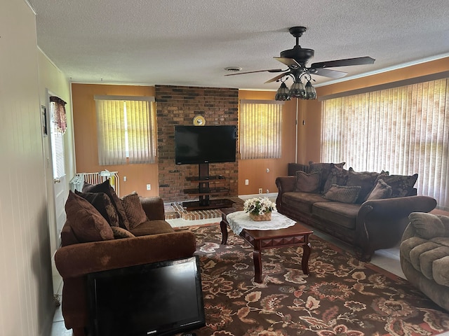 living room with ceiling fan and a textured ceiling