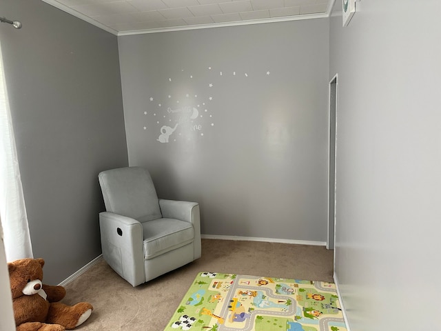 sitting room featuring crown molding and light carpet