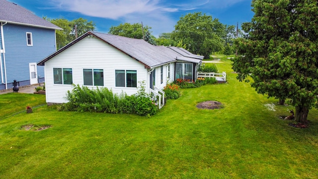 rear view of house with a yard