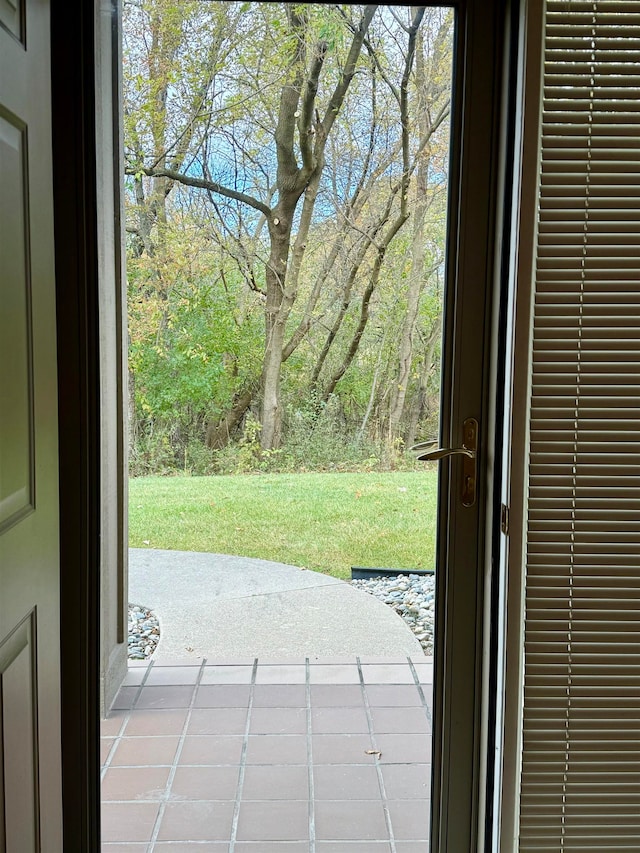 doorway to outside featuring tile patterned floors