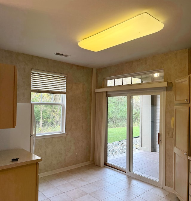 doorway featuring light tile patterned floors