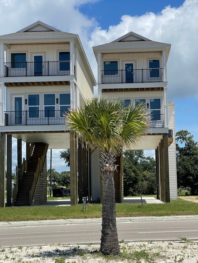 raised beach house with a balcony and a carport