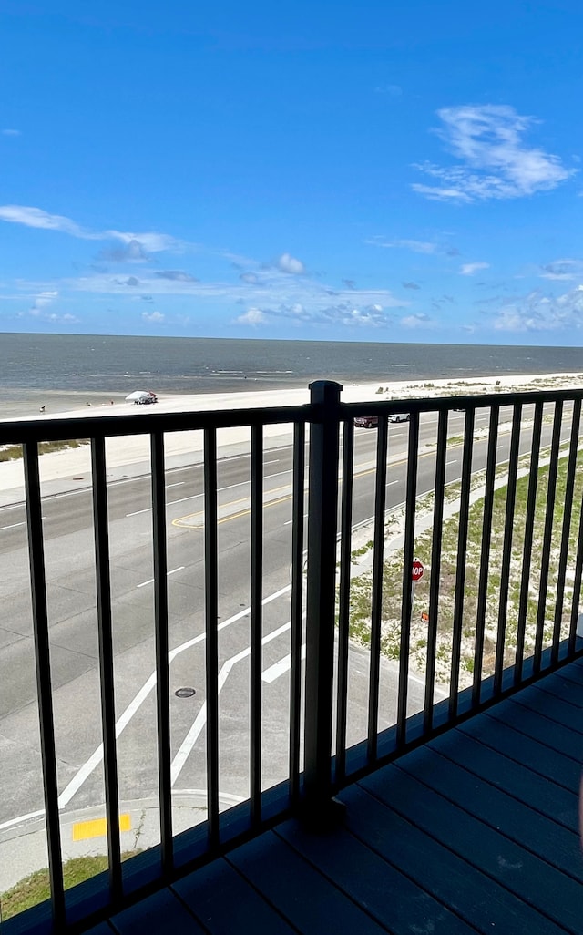 deck with a beach view and a water view