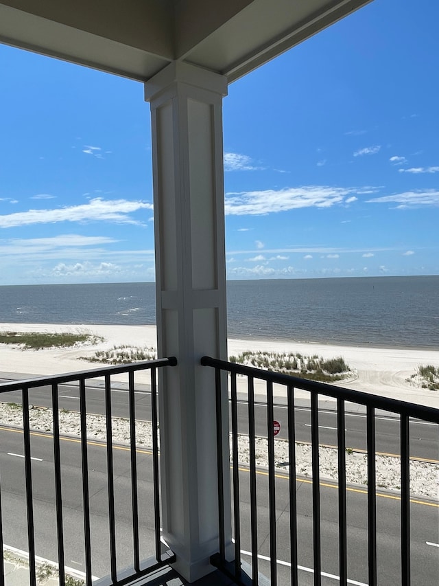 balcony featuring a water view and a view of the beach