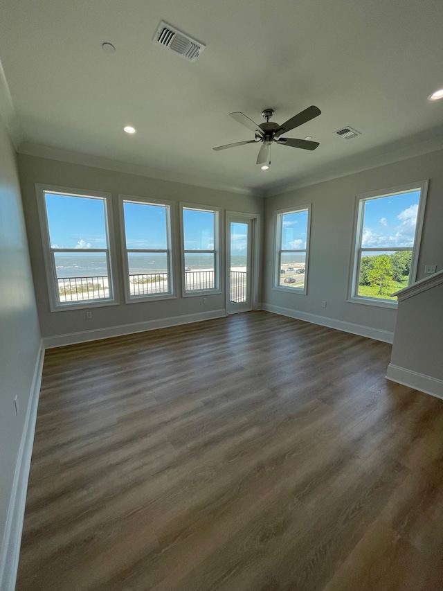 unfurnished room featuring ceiling fan, dark hardwood / wood-style flooring, and crown molding