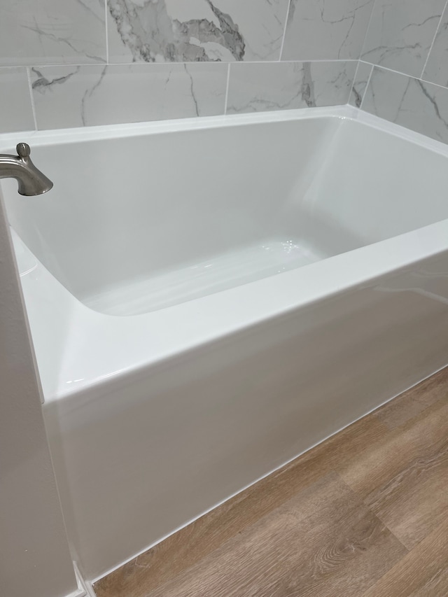 bathroom with hardwood / wood-style floors