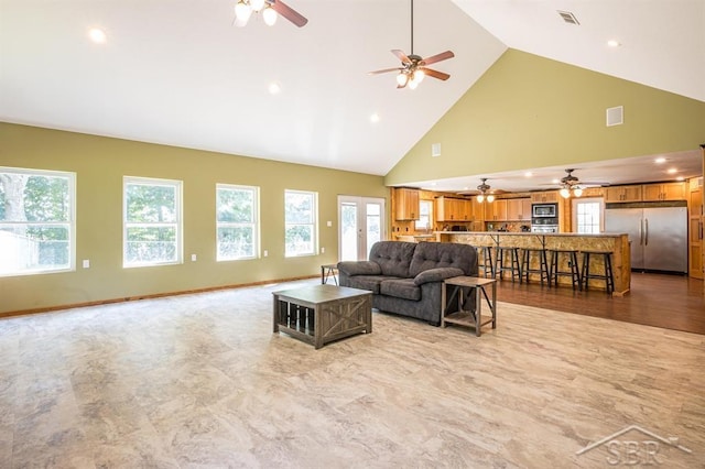 living room featuring a wealth of natural light, high vaulted ceiling, and ceiling fan