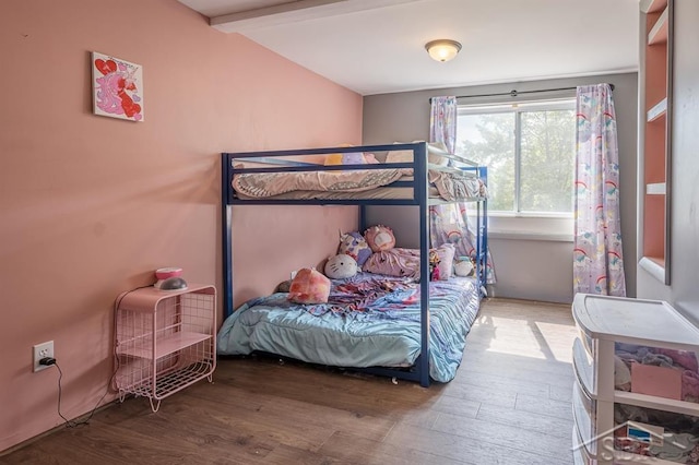 bedroom featuring hardwood / wood-style floors and beamed ceiling