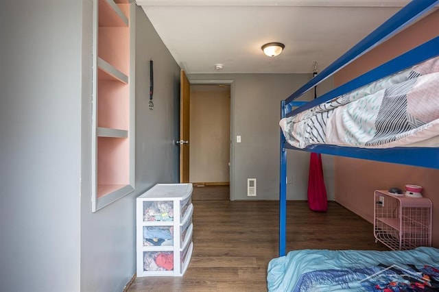 bedroom with dark hardwood / wood-style flooring