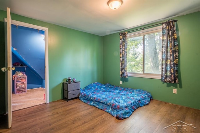 bedroom with hardwood / wood-style floors