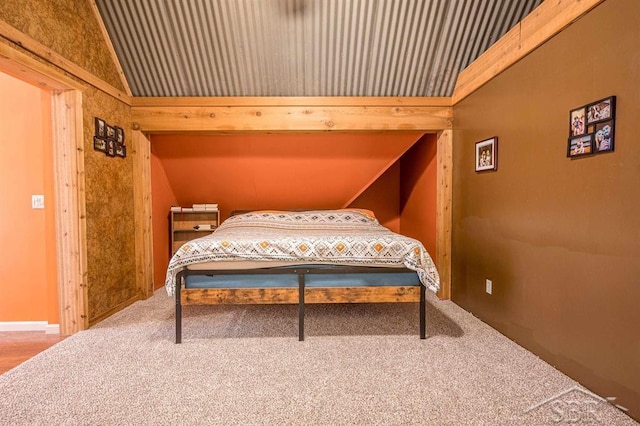 bedroom featuring carpet floors and lofted ceiling