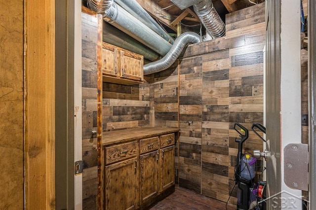 bathroom with hardwood / wood-style flooring and wood walls