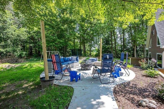 view of patio with a fire pit and a trampoline