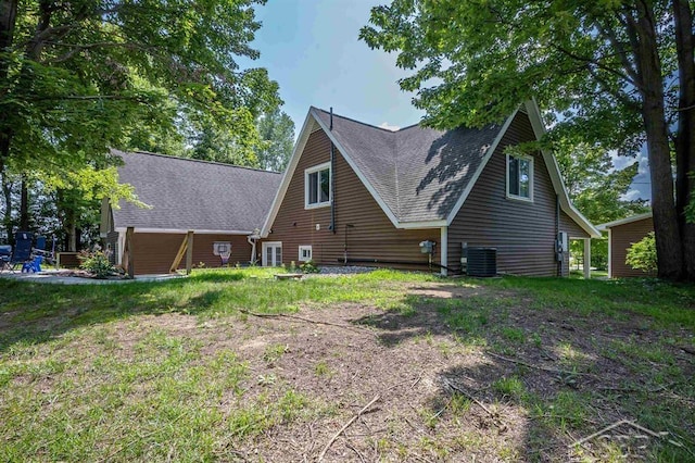 rear view of house featuring central AC unit