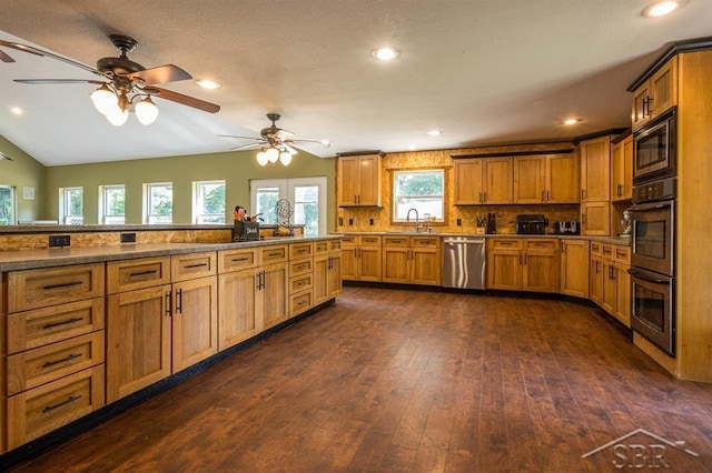 kitchen with backsplash, dark wood-type flooring, sink, light stone counters, and stainless steel appliances