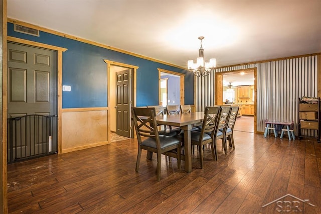 dining area featuring dark hardwood / wood-style floors and a notable chandelier