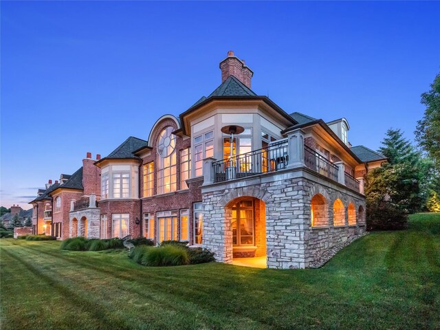2756 Turtle Bluff Dr, Bloomfield Hills, MI 48302 - view of front of house featuring a balcony, a front yard, stone siding, and a chimney
