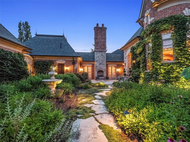 2756 Turtle Bluff Dr, Bloomfield Hills, MI 48302 - rear view of property with a high end roof, brick siding, and a chimney