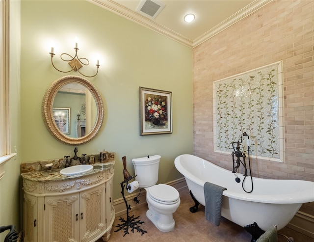 bathroom with ornamental molding, vanity, tile patterned flooring, toilet, and a tub