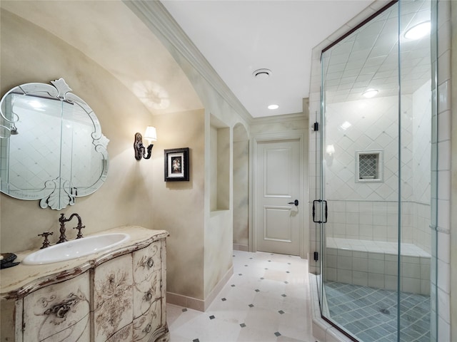 bathroom featuring ornamental molding, vanity, and a shower with shower door