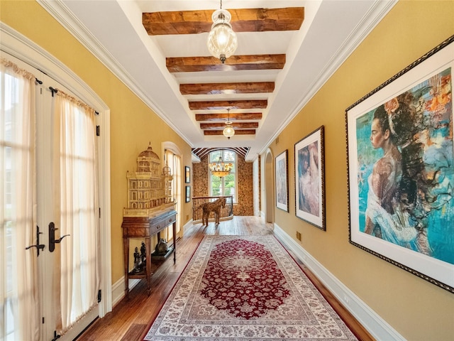 hallway featuring a notable chandelier, beam ceiling, wood-type flooring, and french doors