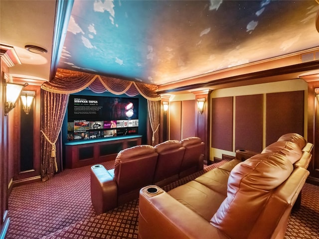 carpeted cinema room with crown molding