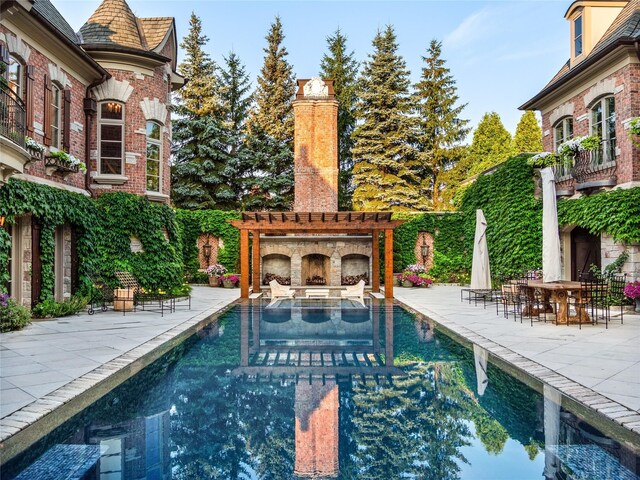 2756 Turtle Bluff Dr, Bloomfield Hills, MI 48302 - view of pool with a patio area and an outdoor stone fireplace