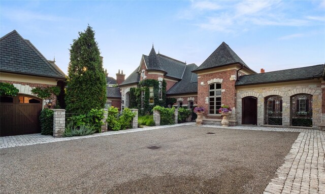 2756 Turtle Bluff Dr, Bloomfield Hills, MI 48302 - french country home featuring a gate, stone siding, a high end roof, and brick siding
