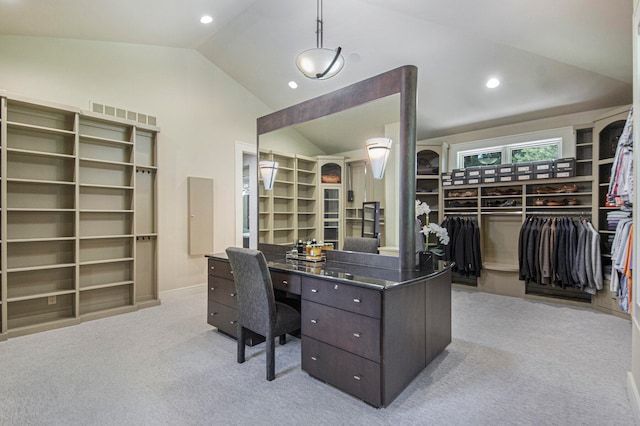 office area with light colored carpet and vaulted ceiling