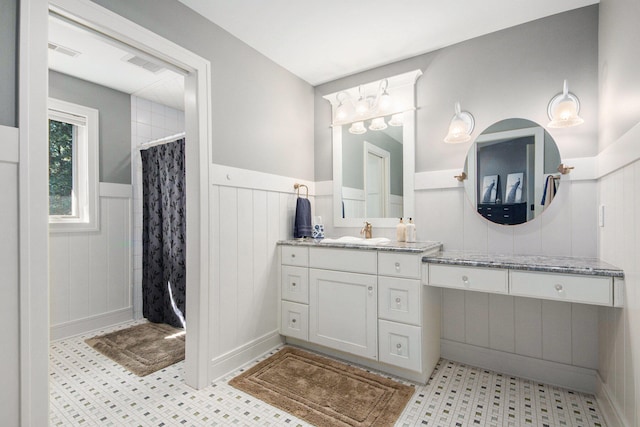 bathroom featuring vanity and a shower with shower curtain