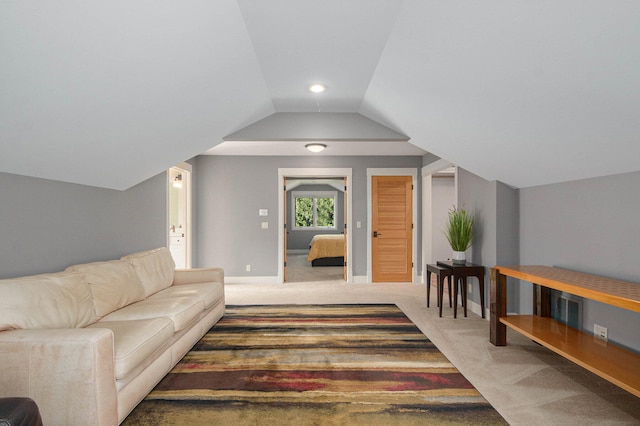 carpeted living room with vaulted ceiling