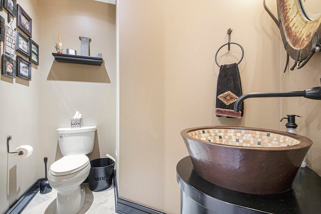 bathroom with tile patterned floors, toilet, and sink