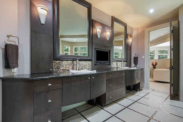 bathroom featuring vanity and tasteful backsplash