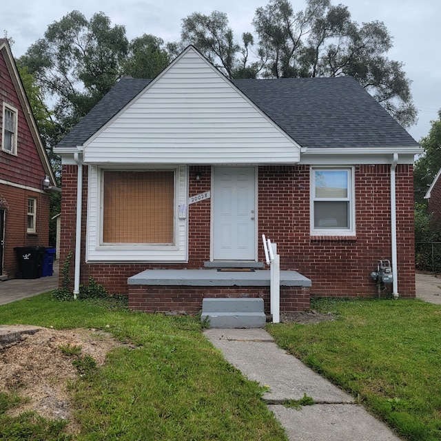 bungalow-style house with a front yard