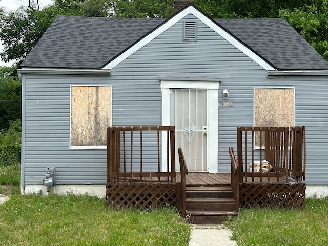 back of house with a deck