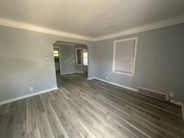 spare room featuring ornamental molding and hardwood / wood-style flooring