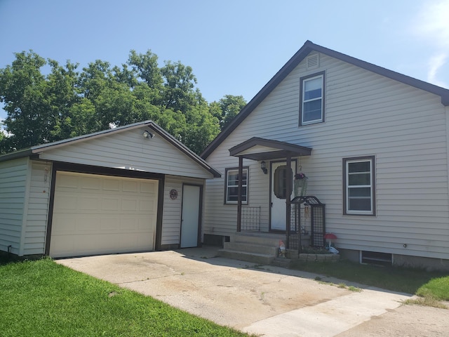 view of front of property featuring a garage, driveway, and an outdoor structure