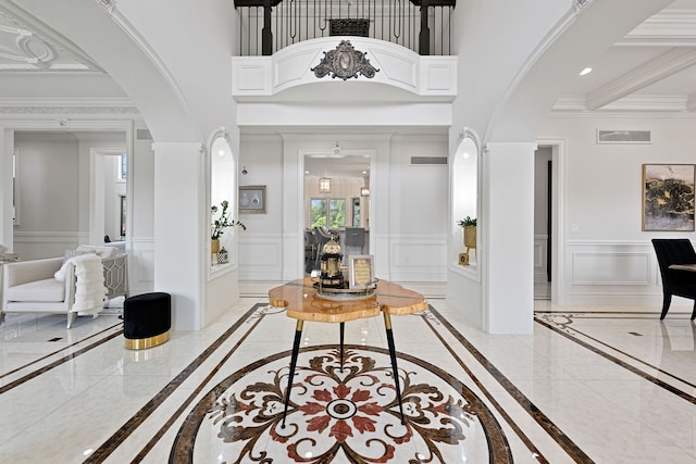 entryway with a high ceiling and ornamental molding