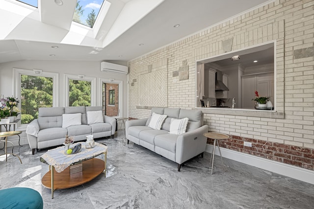 living room featuring a wall mounted air conditioner, vaulted ceiling with skylight, sink, and brick wall