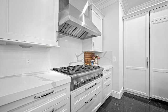 kitchen with stainless steel gas stovetop, wall chimney exhaust hood, white cabinets, and light stone counters