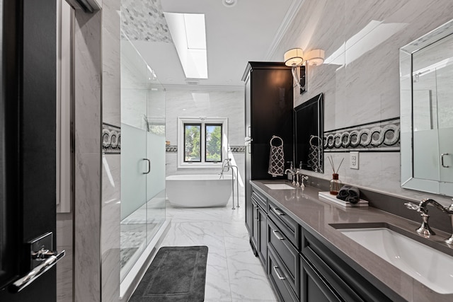 bathroom featuring a skylight, plus walk in shower, crown molding, vanity, and tile walls