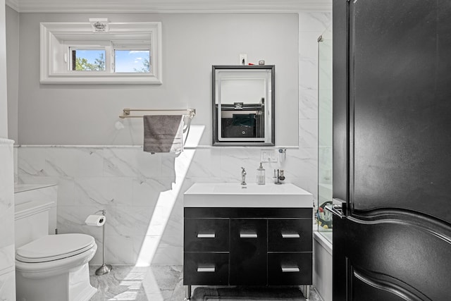 bathroom with vanity, ornamental molding, tile walls, and toilet