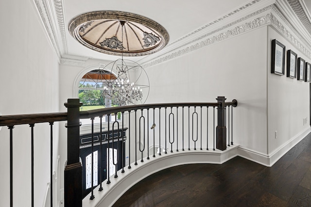 staircase with a chandelier, ornamental molding, and hardwood / wood-style flooring