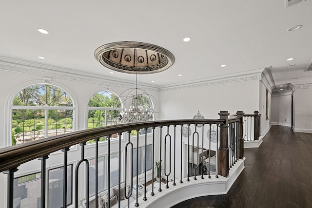 hallway with dark hardwood / wood-style floors, crown molding, and a notable chandelier