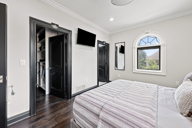 bedroom with crown molding and dark wood-type flooring