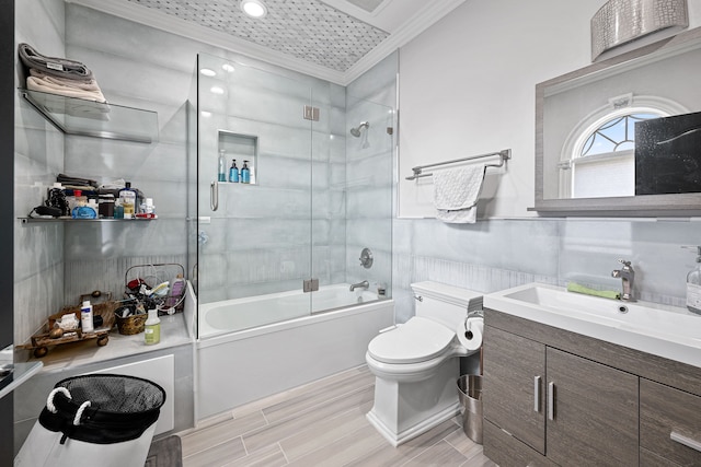 full bathroom featuring hardwood / wood-style floors, vanity, crown molding, toilet, and enclosed tub / shower combo