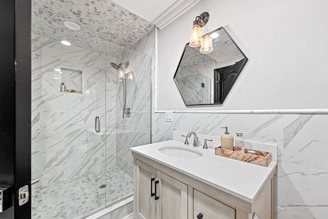 bathroom with vanity, an enclosed shower, ornamental molding, and tile walls