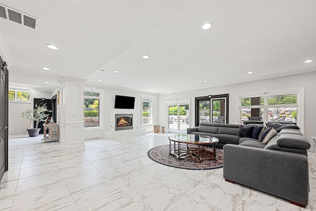 living room with a healthy amount of sunlight and ornamental molding