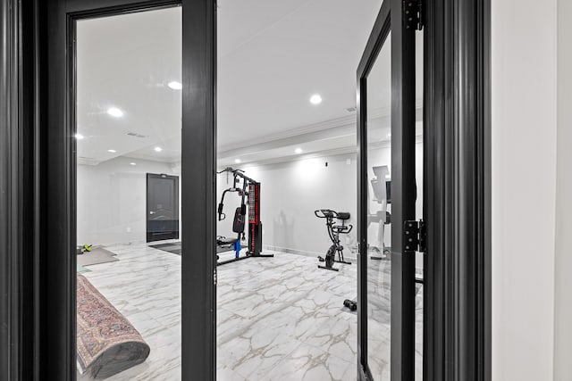 workout area featuring ornamental molding