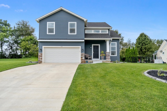 view of front of home featuring a garage and a front lawn